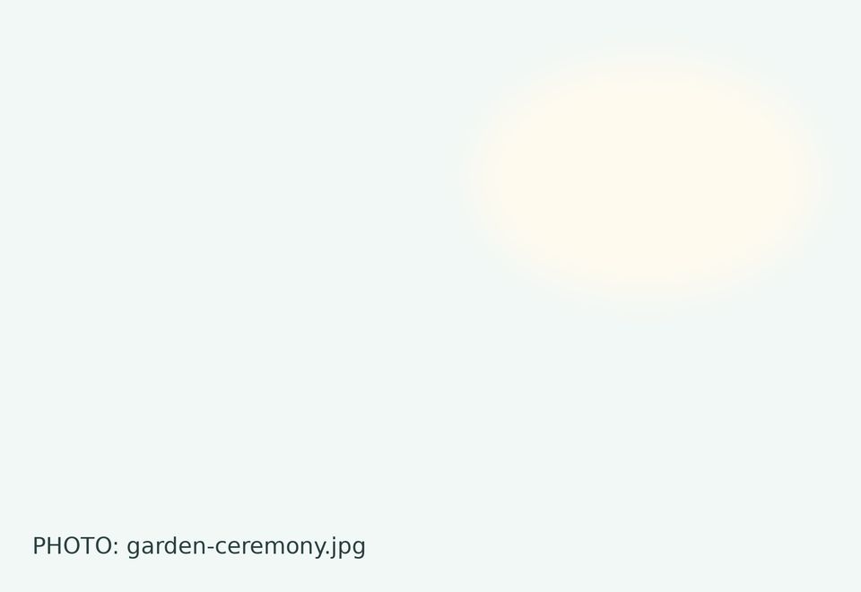 A wedding ceremony beneath a large garden tree